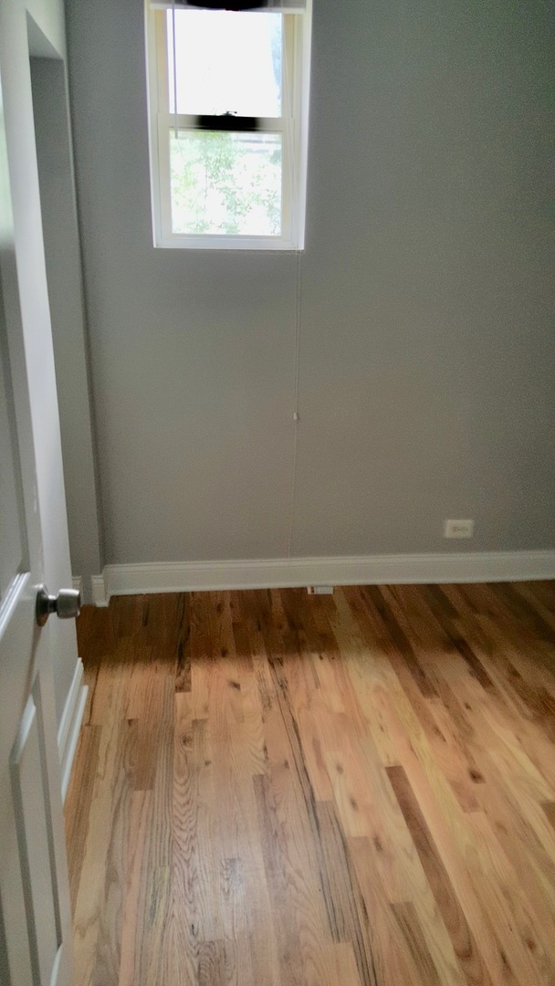 5708 South Aberdeen Street Chicago, IL 60621 - Photo 10 of 25 a view of a room with wooden floor and small window
