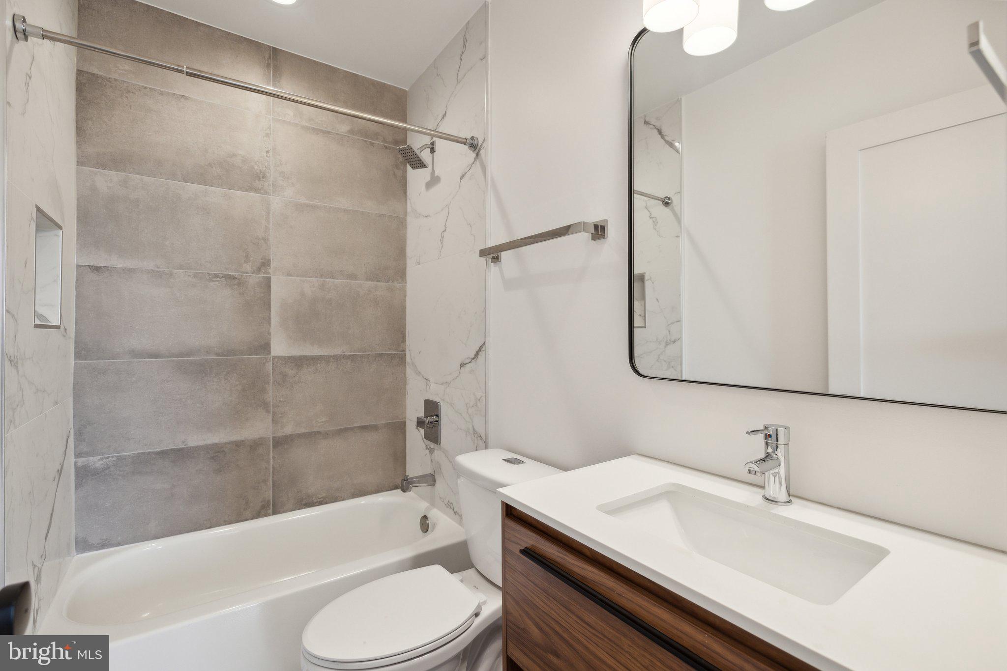 845 19th Street Northeast, Unit PH13 Washington, DC 20002 - Photo 5 of 14 a bathroom with a sink toilet and shower