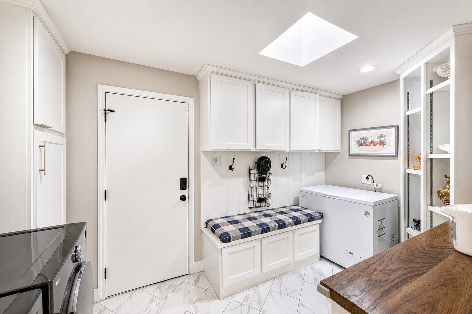 201 Vanderpool Lane, Unit 130 Houston, TX 77024 - Photo 15 of 41 This large utility space doubles as a mudroom with numerous built-in cabinets, a convenient bench and folding table. The LG washer and dryer and chest freezer will convey with the property.