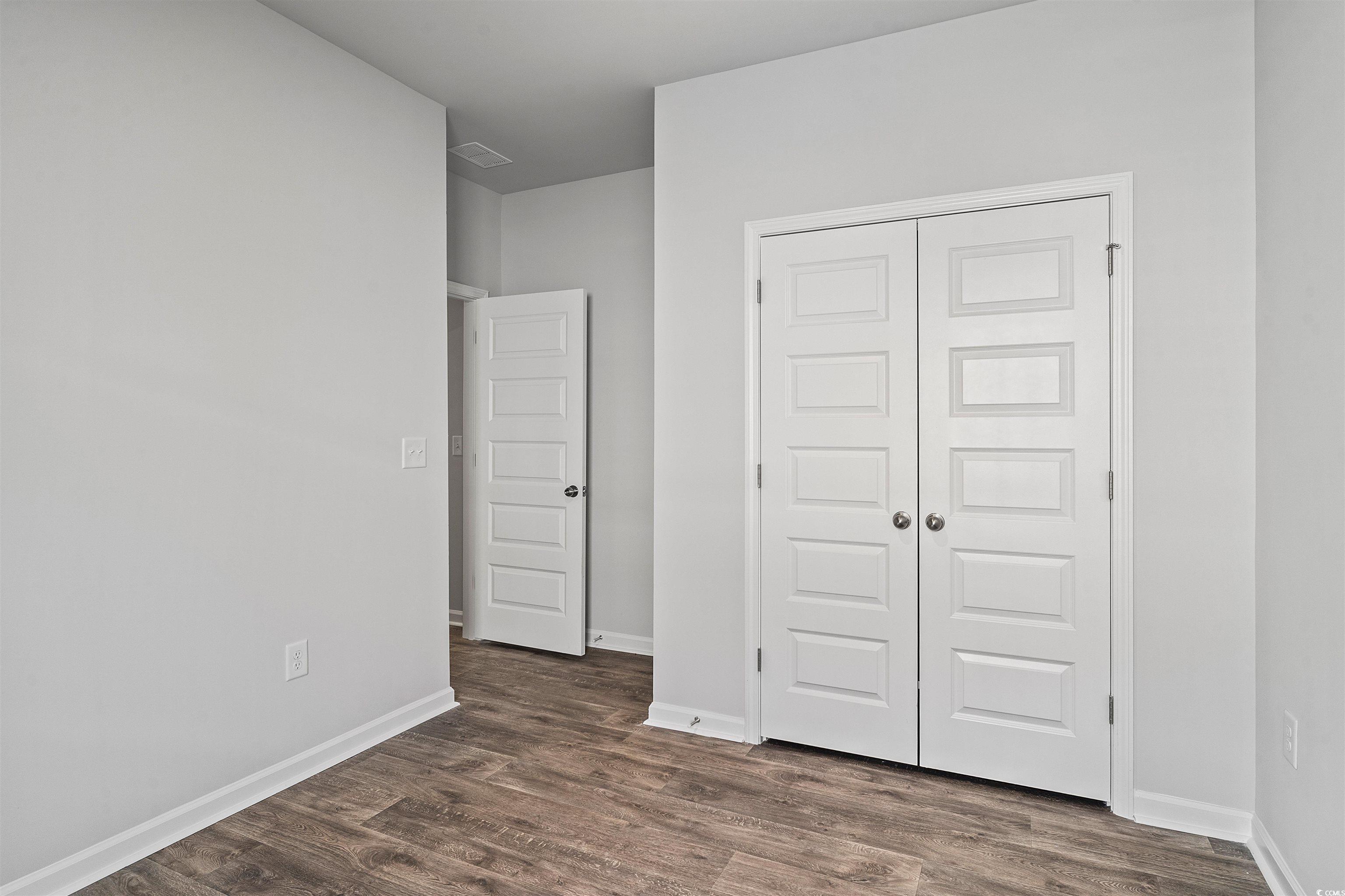 419 Ribbon Rail Way Loris, SC 29569 - Photo 11 of 32 Unfurnished bedroom featuring a closet and dark wo