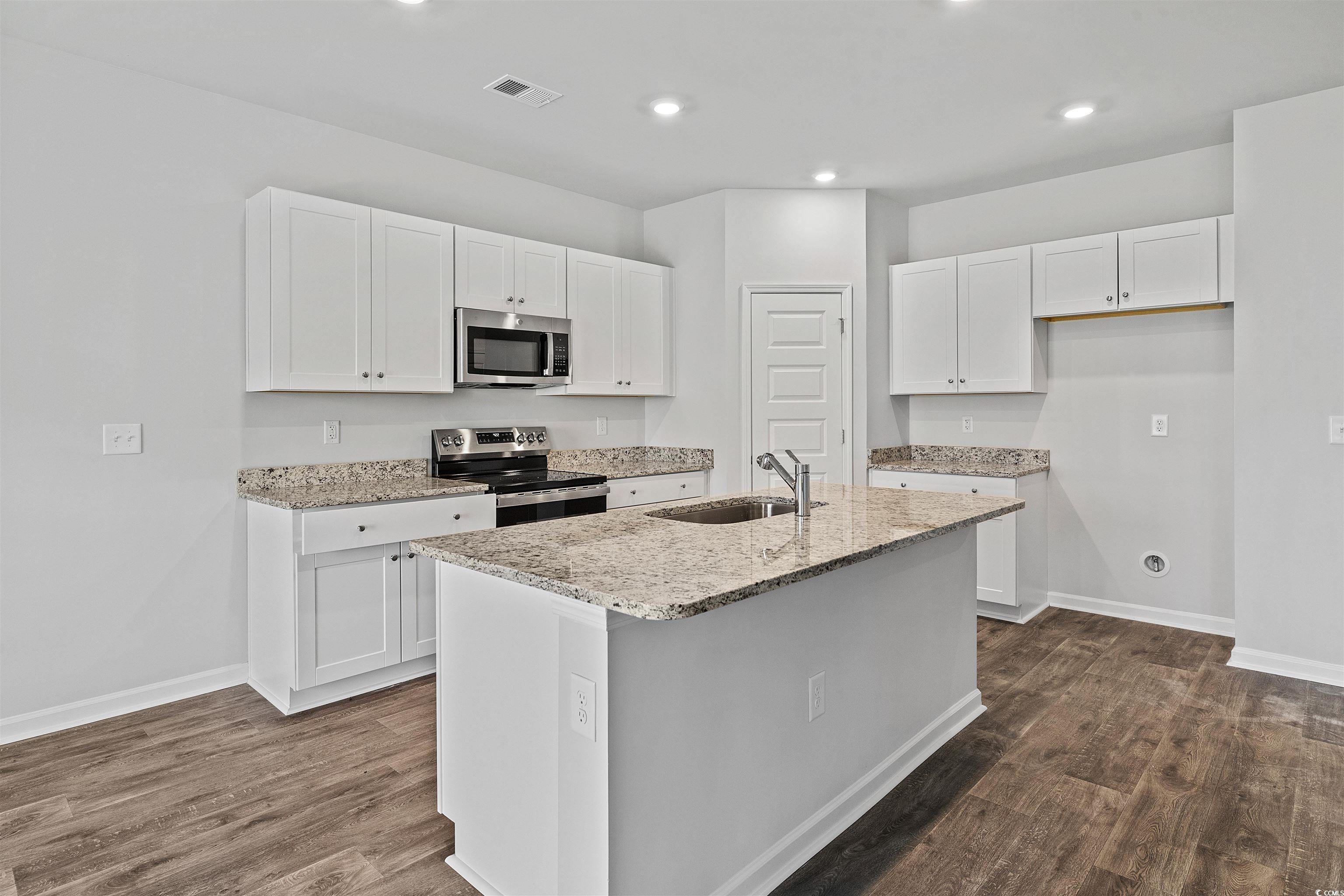 419 Ribbon Rail Way Loris, SC 29569 - Photo 14 of 32 Kitchen with dark wood-type flooring, white cabine