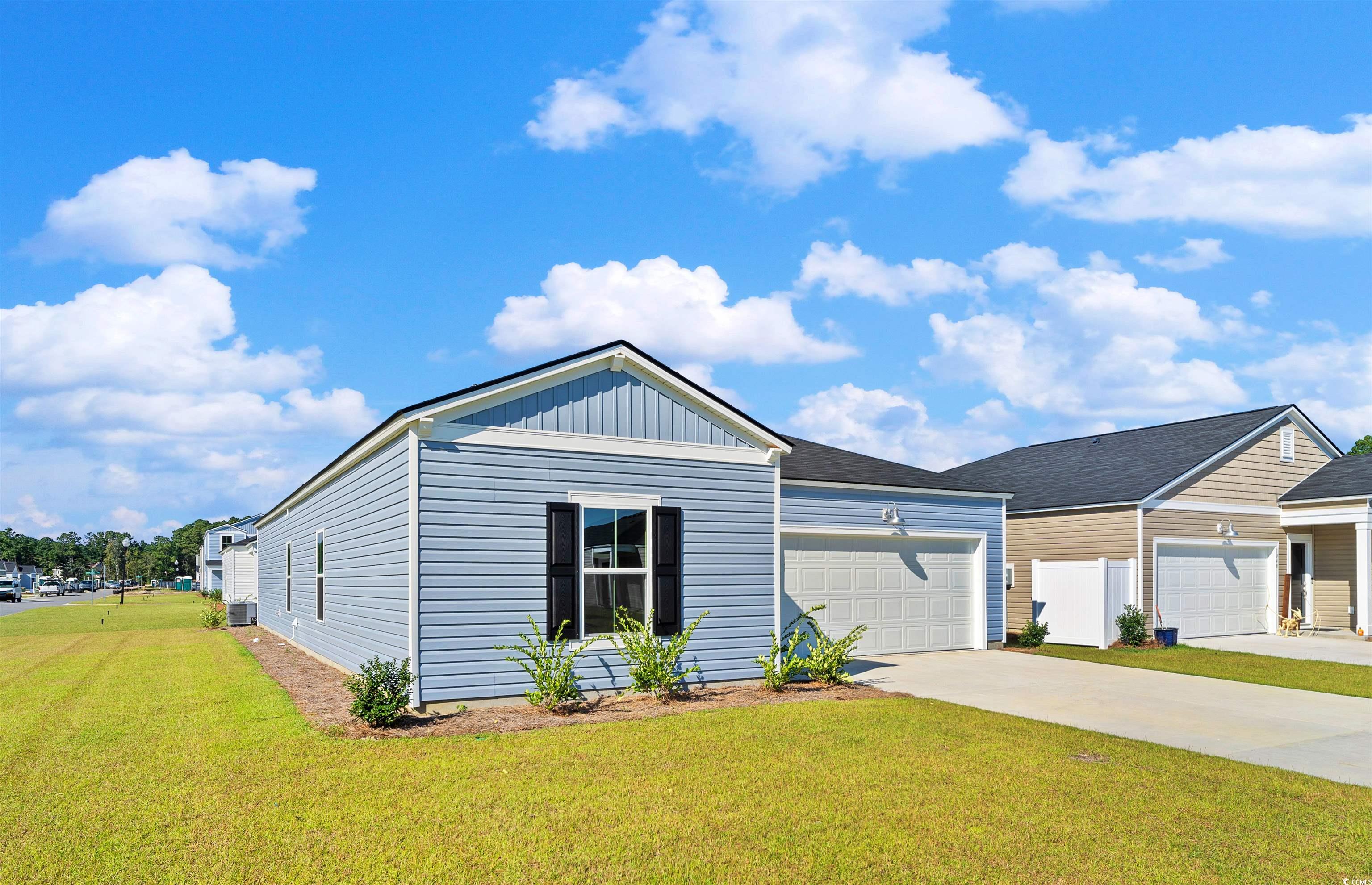 419 Ribbon Rail Way Loris, SC 29569 - Photo 2 of 32 View of front facade with a front yard and a garag