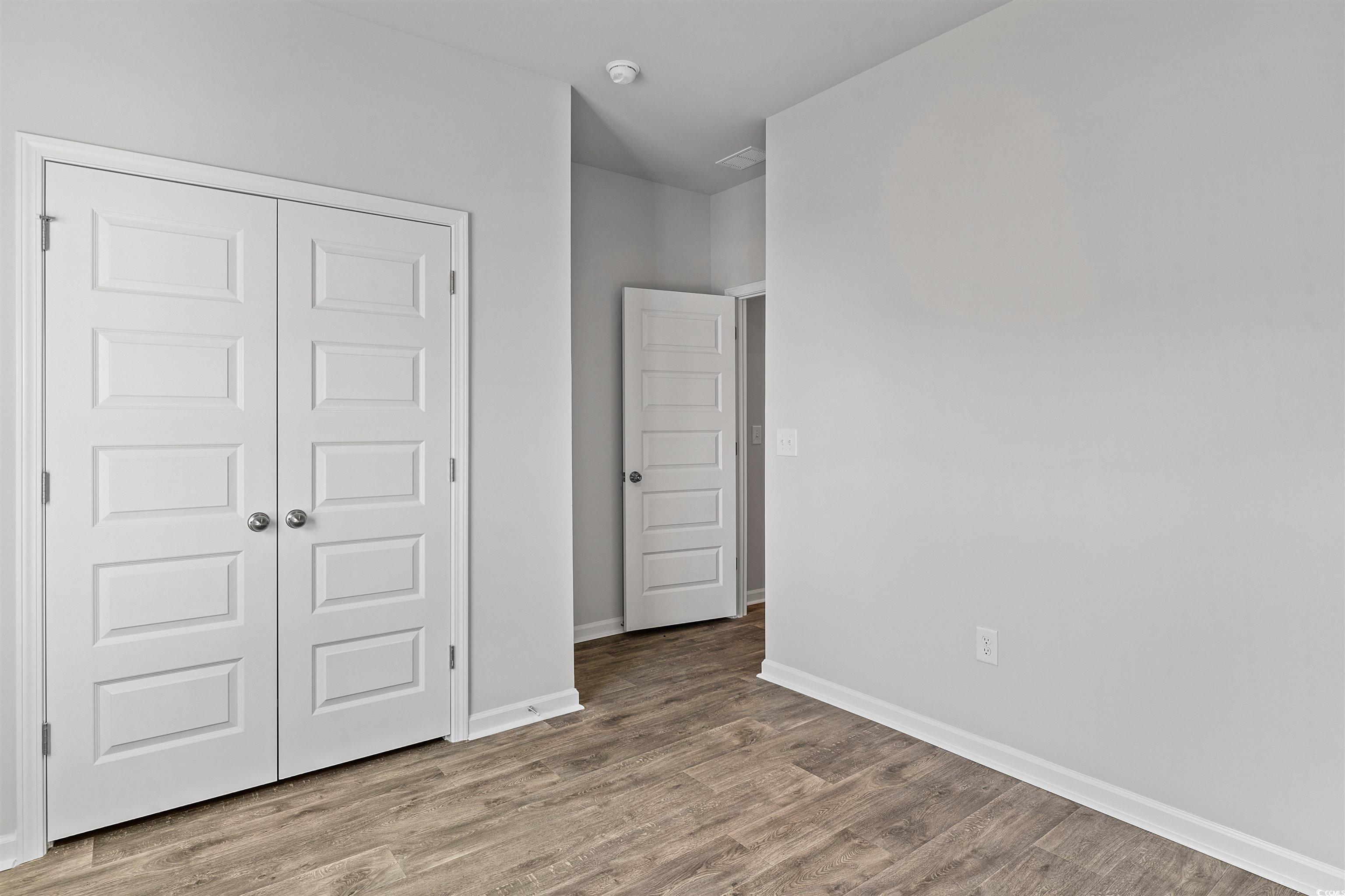419 Ribbon Rail Way Loris, SC 29569 - Photo 6 of 32 Unfurnished bedroom with light hardwood / wood-sty