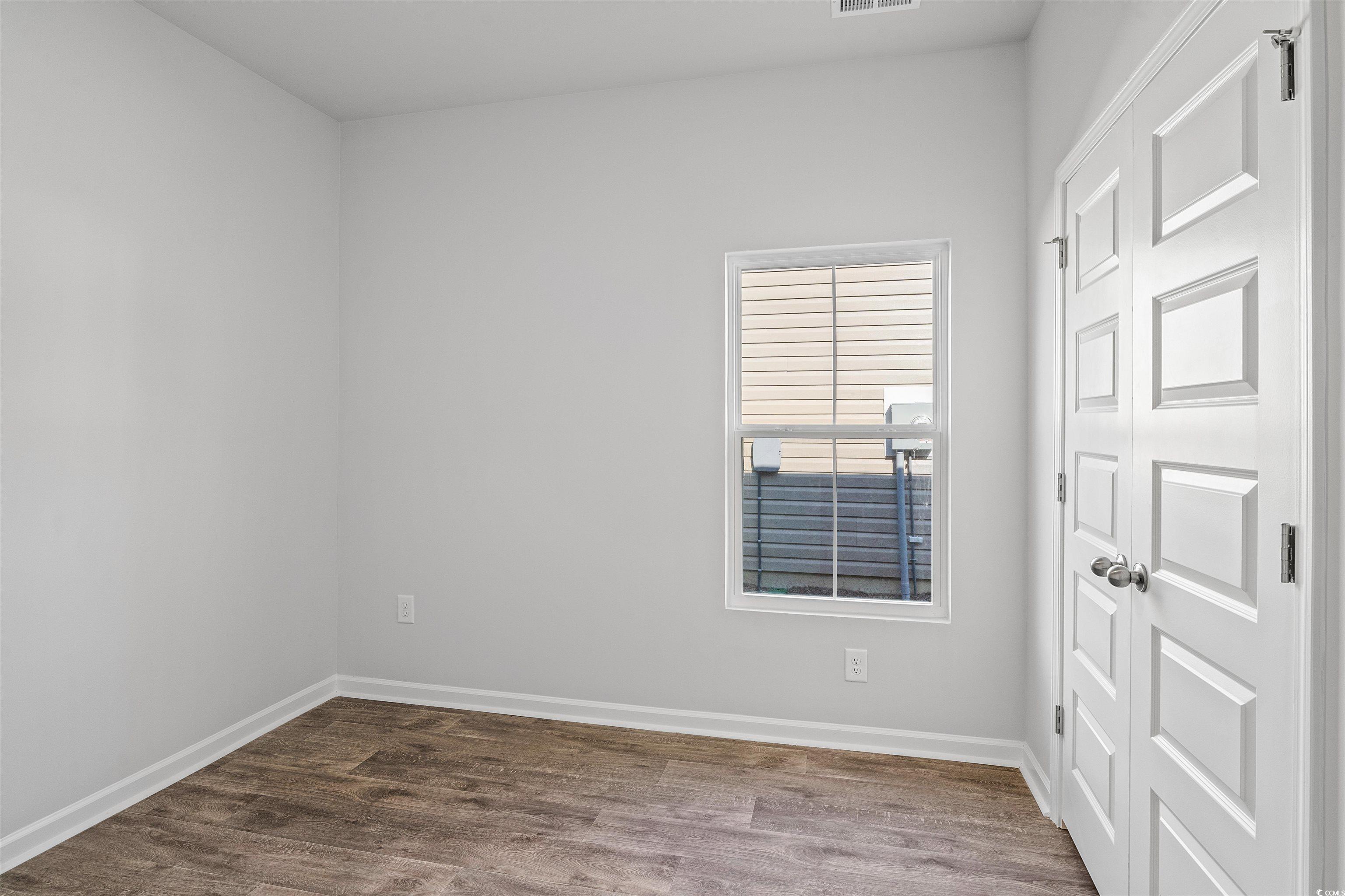 419 Ribbon Rail Way Loris, SC 29569 - Photo 8 of 32 Unfurnished room with wood-type flooring