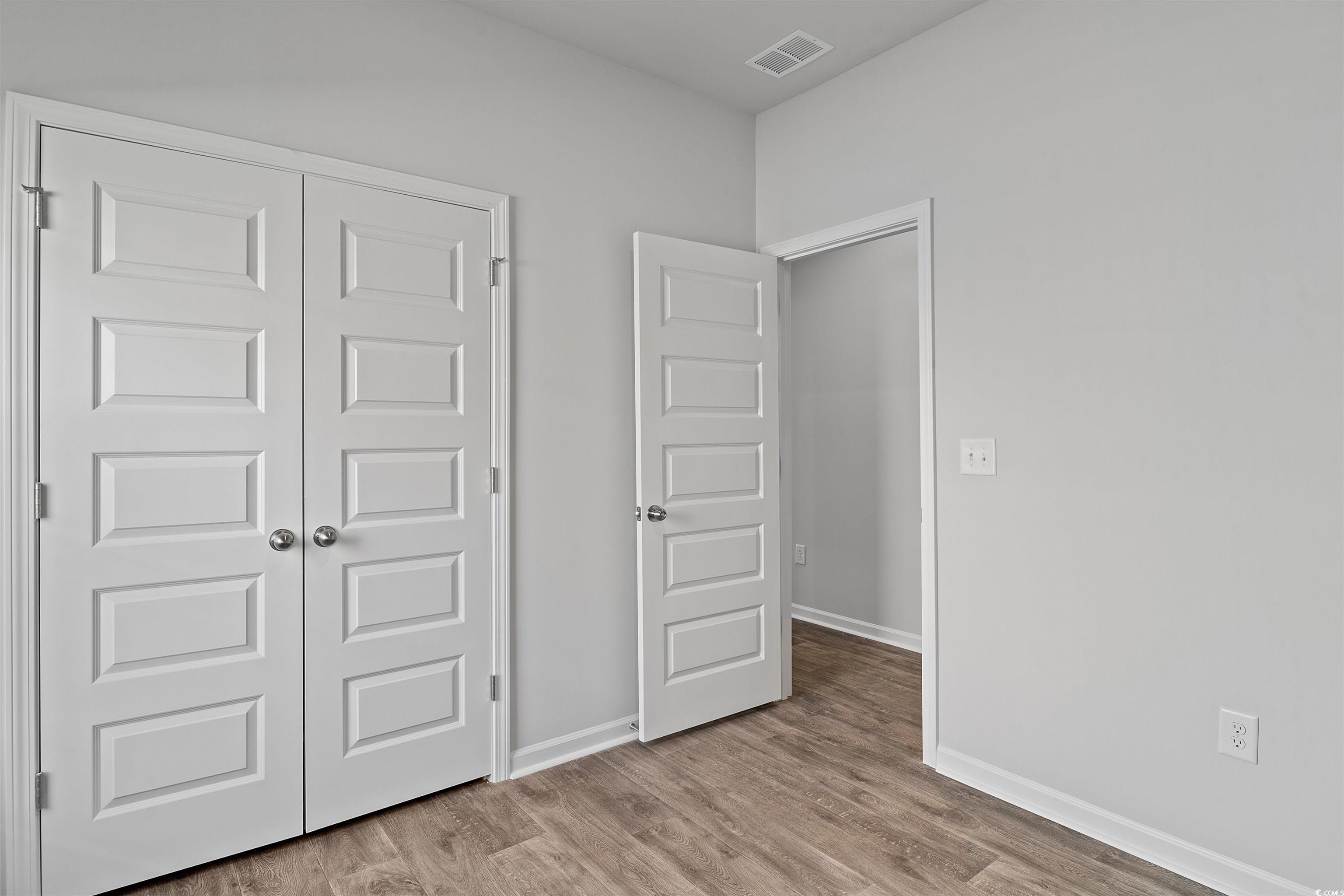 419 Ribbon Rail Way Loris, SC 29569 - Photo 9 of 32 Unfurnished bedroom featuring light hardwood / woo