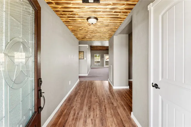 a view of a dining room with furniture wooden floor and chandelier