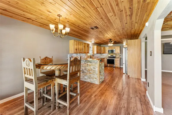 a view of a dining room with furniture wooden floor and chandelier