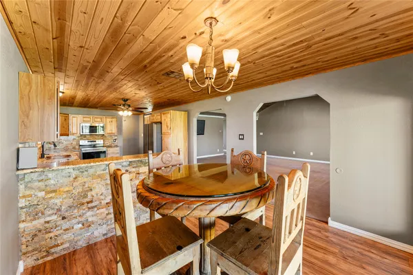 a dining room with furniture and wooden floor
