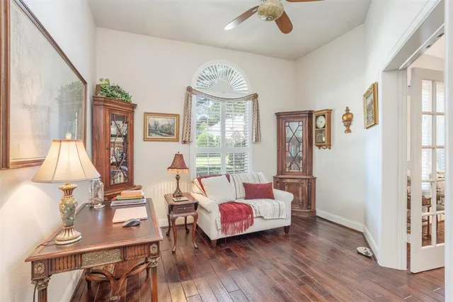 a living room with furniture fireplace and wooden floor