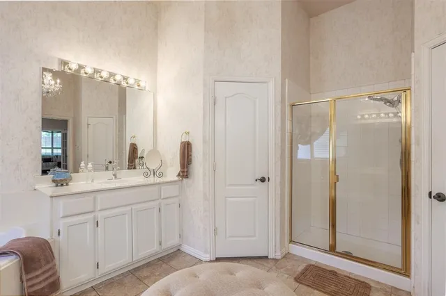 a bathroom with a double vanity sink mirror and shower