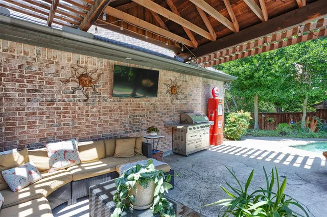 a view of a patio with table and chairs and potted plants