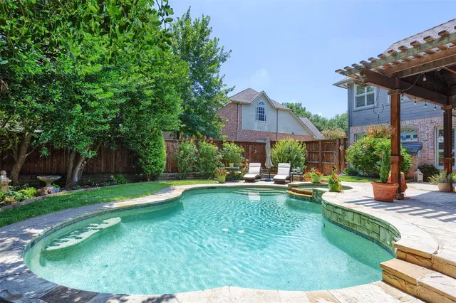 a view of a house with swimming pool and sitting area