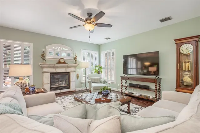 a living room with furniture a fireplace and a flat screen tv