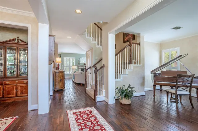 a view of entryway with wooden floor and livingroom view