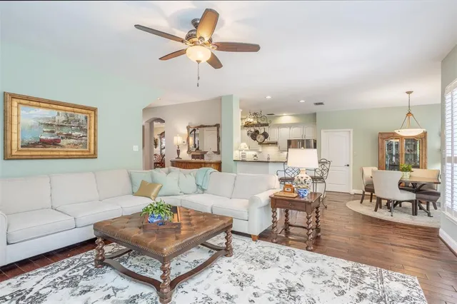 a living room with furniture a rug and a chandelier