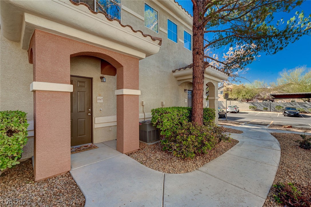 9050 West Warm Springs Road, Unit 1147 Las Vegas, NV 89148 - Photo 1 of 36 A welcoming front entrance with inviting archways, complemented by well-maintained landscaping.