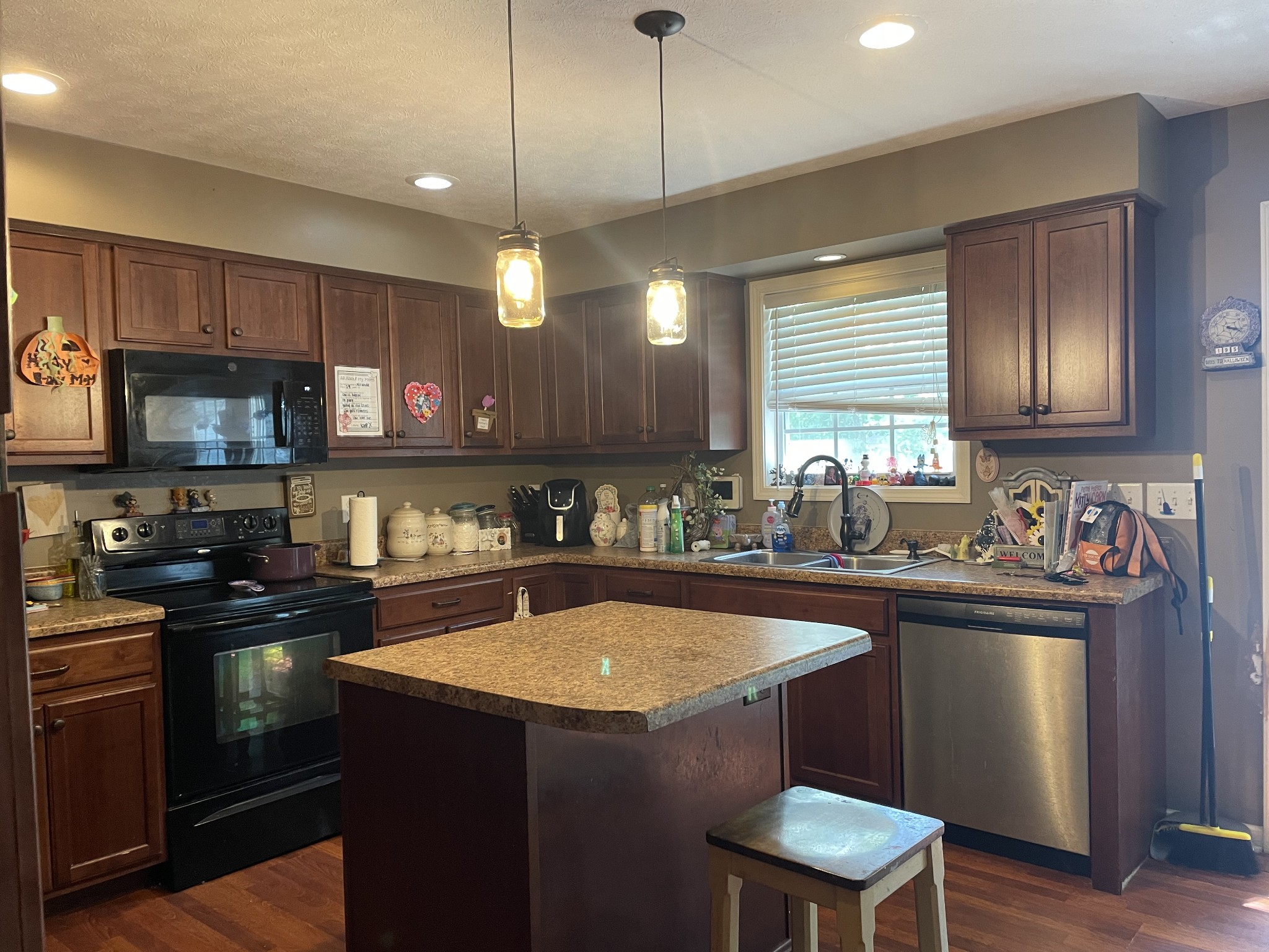 1146 Mt Vernon Road Bethpage, TN 37022 - Photo 6 of 13 a kitchen with a sink a stove a refrigerator cabinets and a kitchen island
