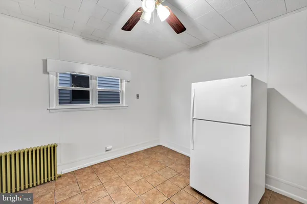 a view of a storage & utility room with a ceiling fan