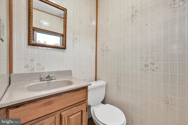 a bathroom with a sink a toilet and a mirror