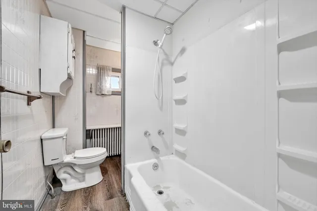 a white bath tub sitting next to a white toilet