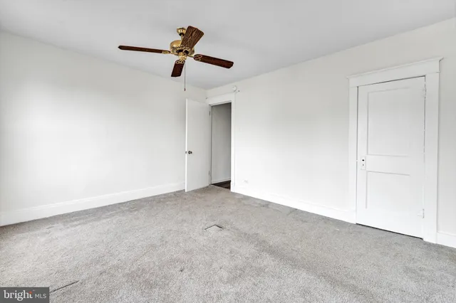 a view of a street with couches and a fire pit