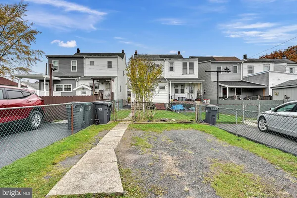 a view of a house with backyard sitting area and garden
