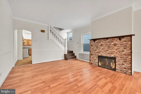 a view of empty room with wooden floor and fireplace