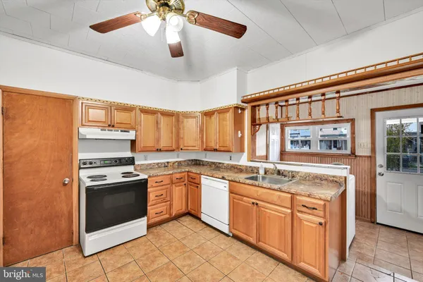 a kitchen with stainless steel appliances granite countertop stove top oven a sink and dishwasher