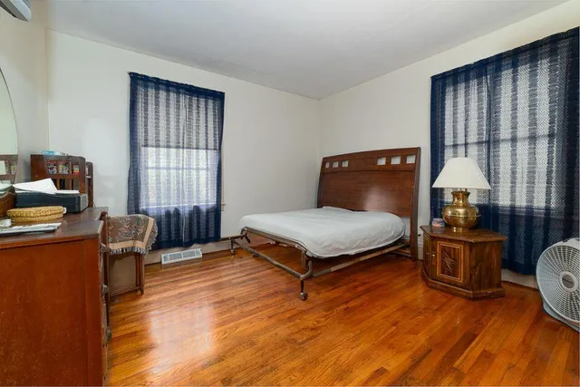 a bedroom with furniture window and wooden floor