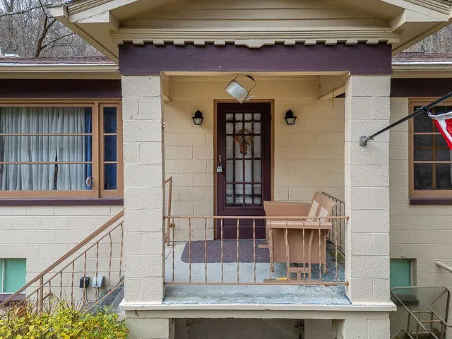 a view of front door of house with glass door