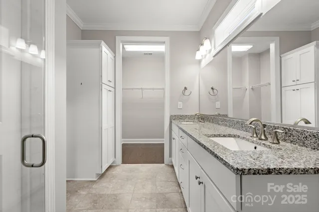 a bathroom with a granite countertop sink a shower and a mirror