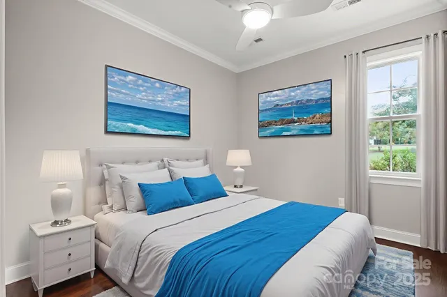 a bedroom with a bed and a painting on the wall