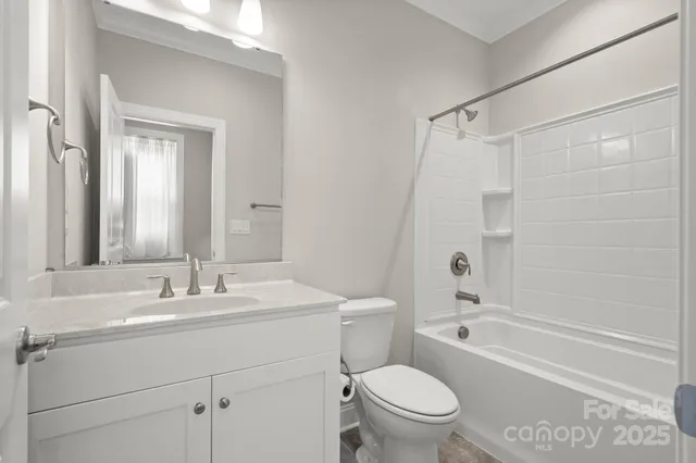 a bathroom with a sink a mirror toilet and bathtub