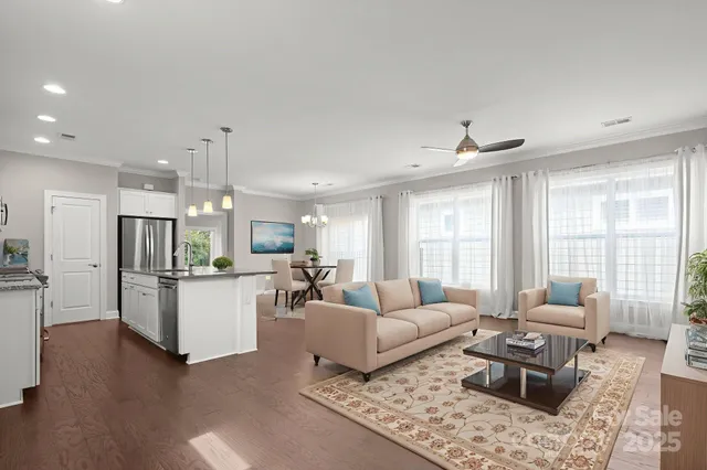 a living room with furniture and kitchen view