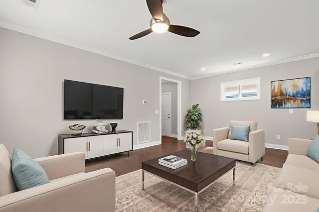 a living room with furniture and a flat screen tv