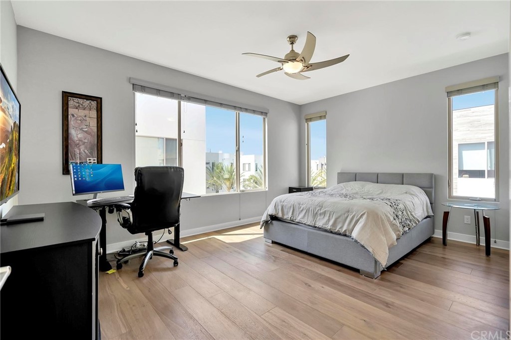 57 Ebb Tide Circle Newport Beach, CA 92663 - Photo 6 of 12 a bedroom with a large bed and a desk