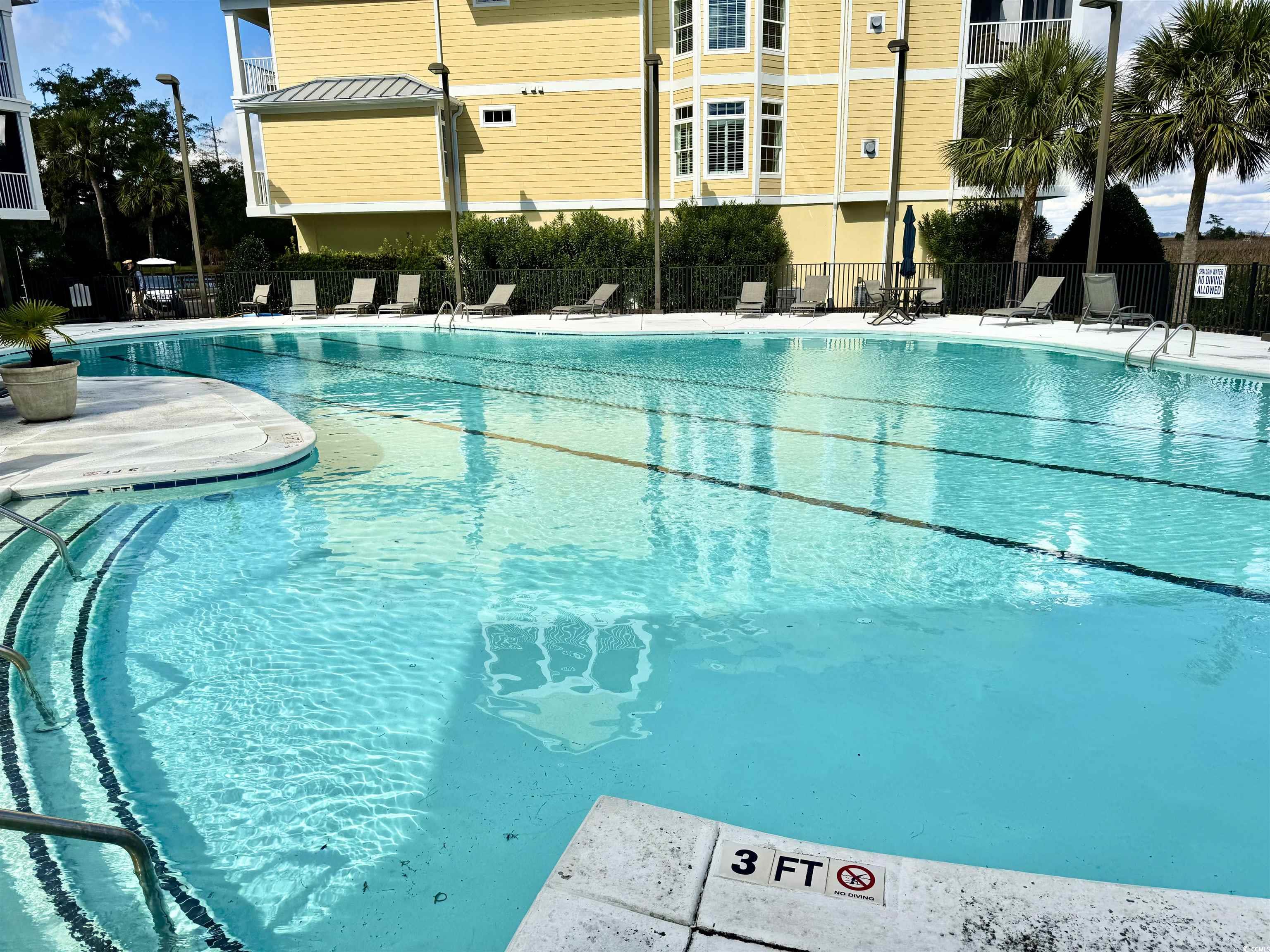 31 Battery White Court, Unit 1005 Georgetown, SC 29440 - Photo 23 of 34 Community pool featuring a patio