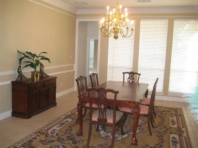 a view of a dining room with furniture and a chandelier