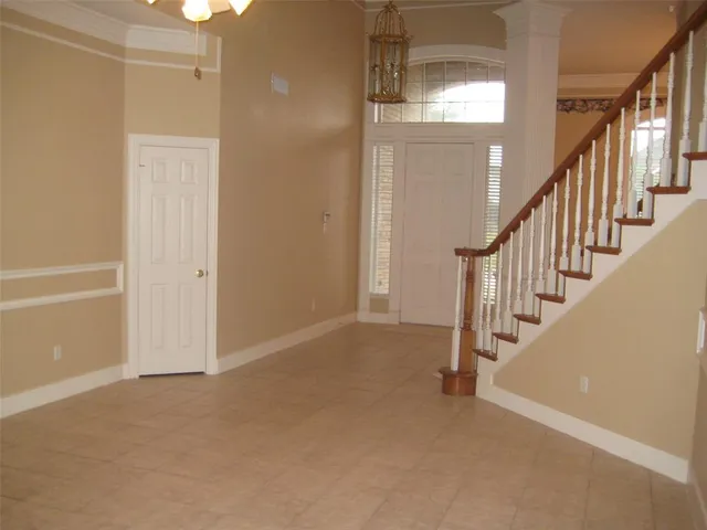 a view of an empty room with stairs