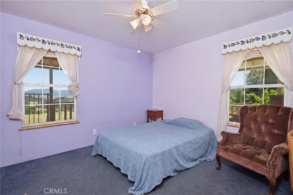 16965 Spruce Grove Road Hidden Valley Lake, CA 95467 - Photo 17 of 34 a bedroom with a bed and a couch