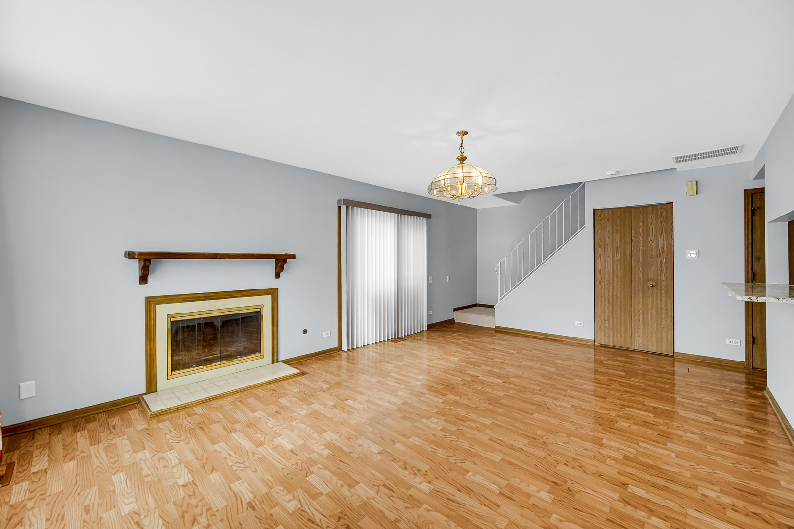 369 North Gregory Street Aurora, IL 60504 - Photo 2 of 18 a view of empty room with wooden floor and fireplace