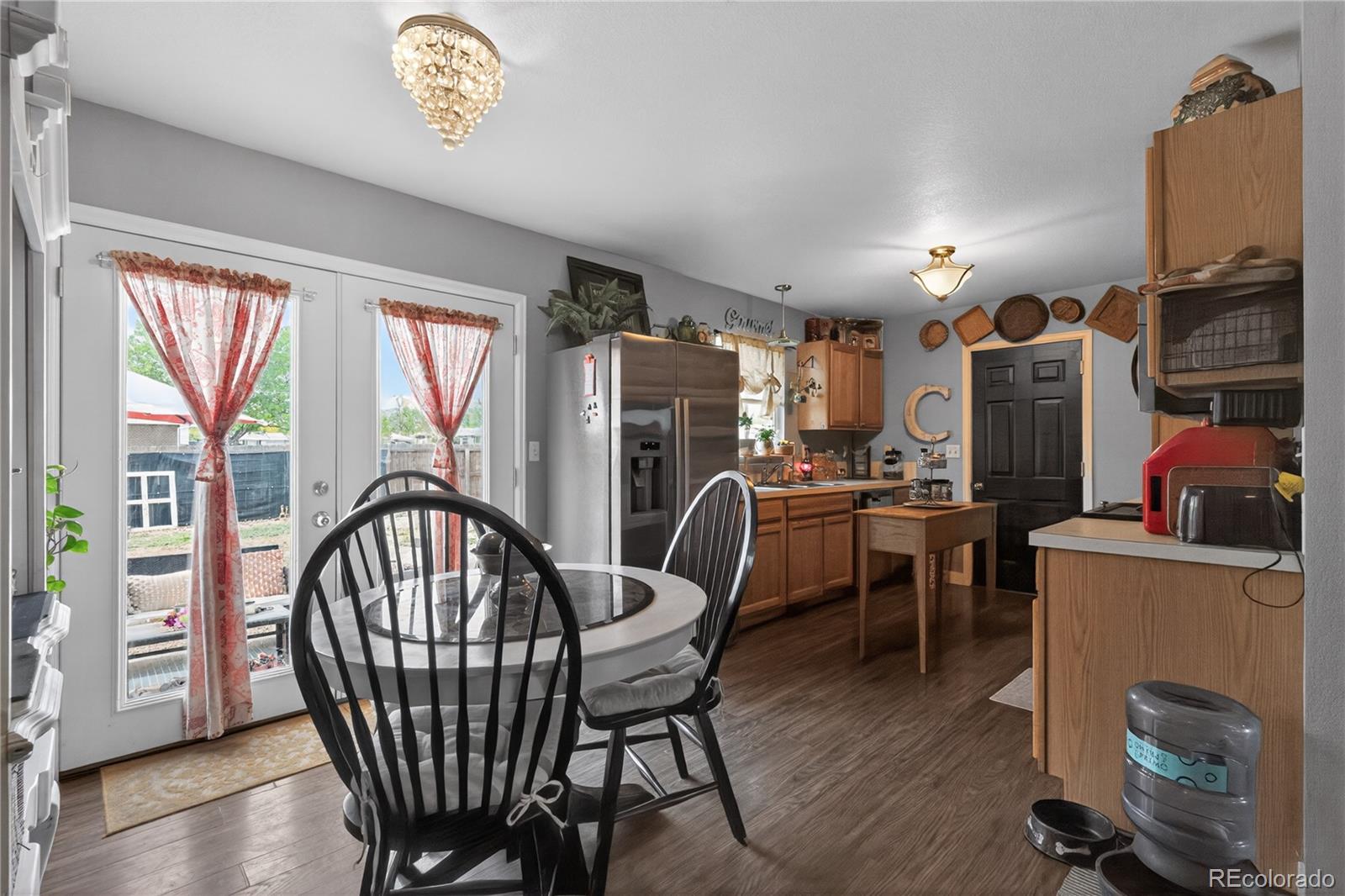 3170 West 3rd Street Road Greeley, CO 80631 - Photo 19 of 29 a view of a dining room with furniture window and wooden floor