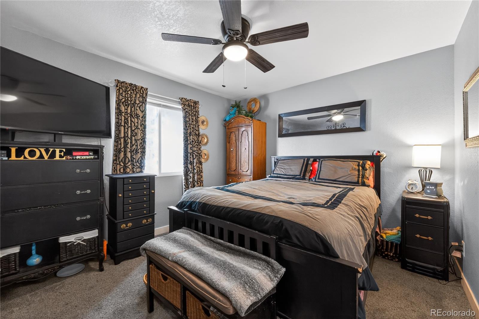 3170 West 3rd Street Road Greeley, CO 80631 - Photo 20 of 29 a bedroom with a bed and a chandelier