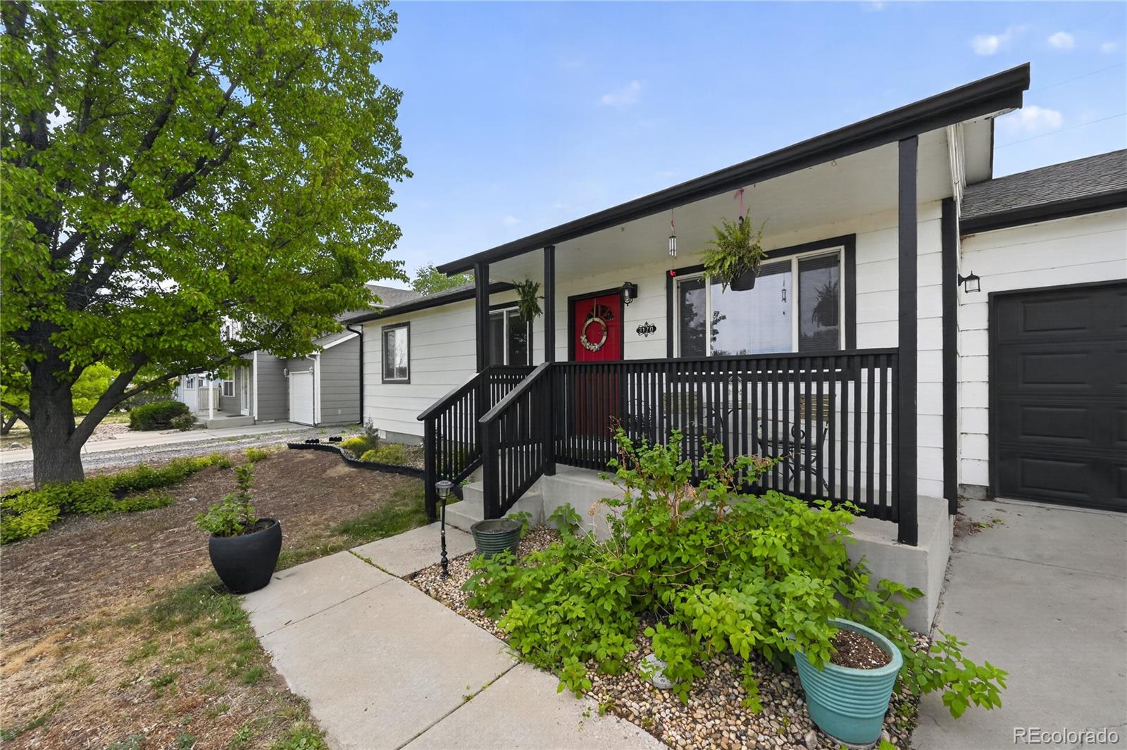 3170 West 3rd Street Road Greeley, CO 80631 - Photo 2 of 29 a front view of a house with garden