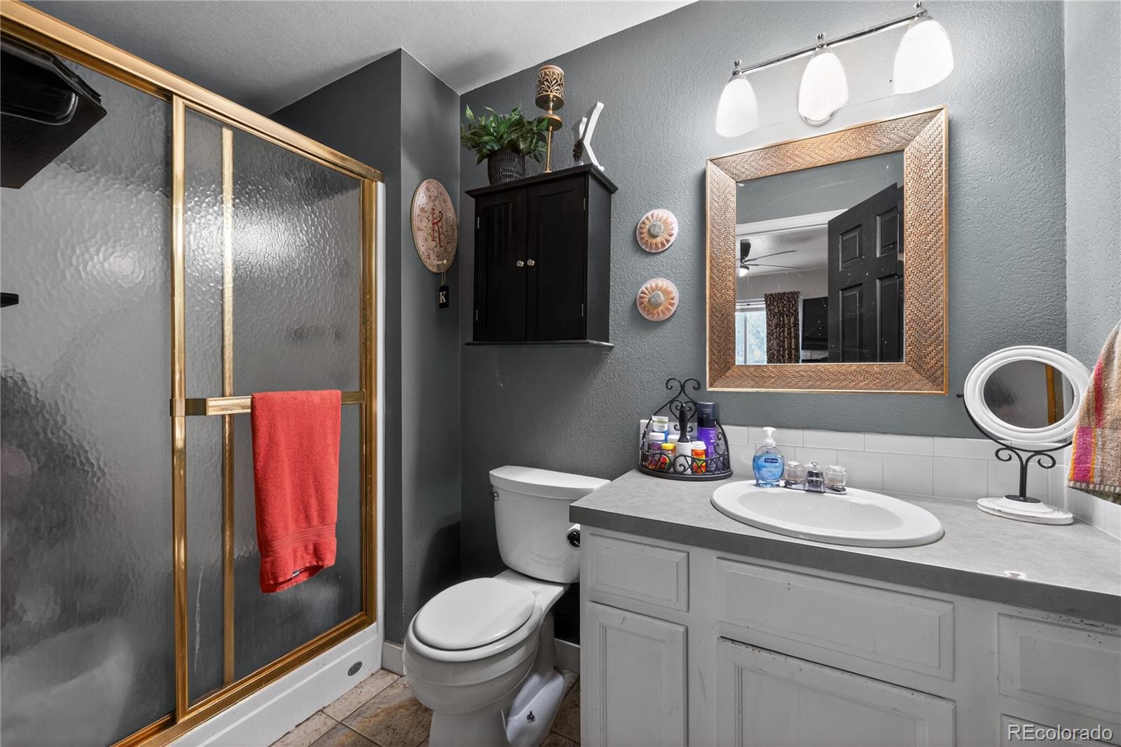 3170 West 3rd Street Road Greeley, CO 80631 - Photo 23 of 29 a bathroom with a sink vanity mirror and toilet