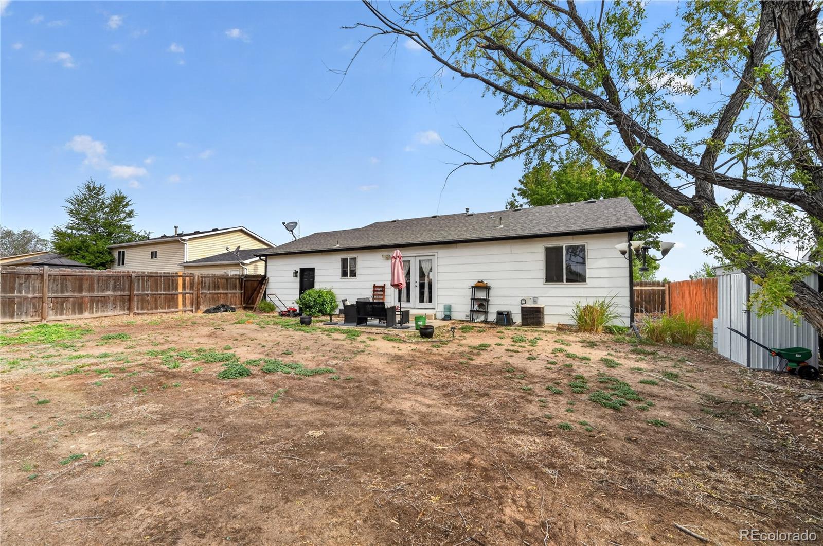 3170 West 3rd Street Road Greeley, CO 80631 - Photo 27 of 29 a view of a house with a backyard and a tree