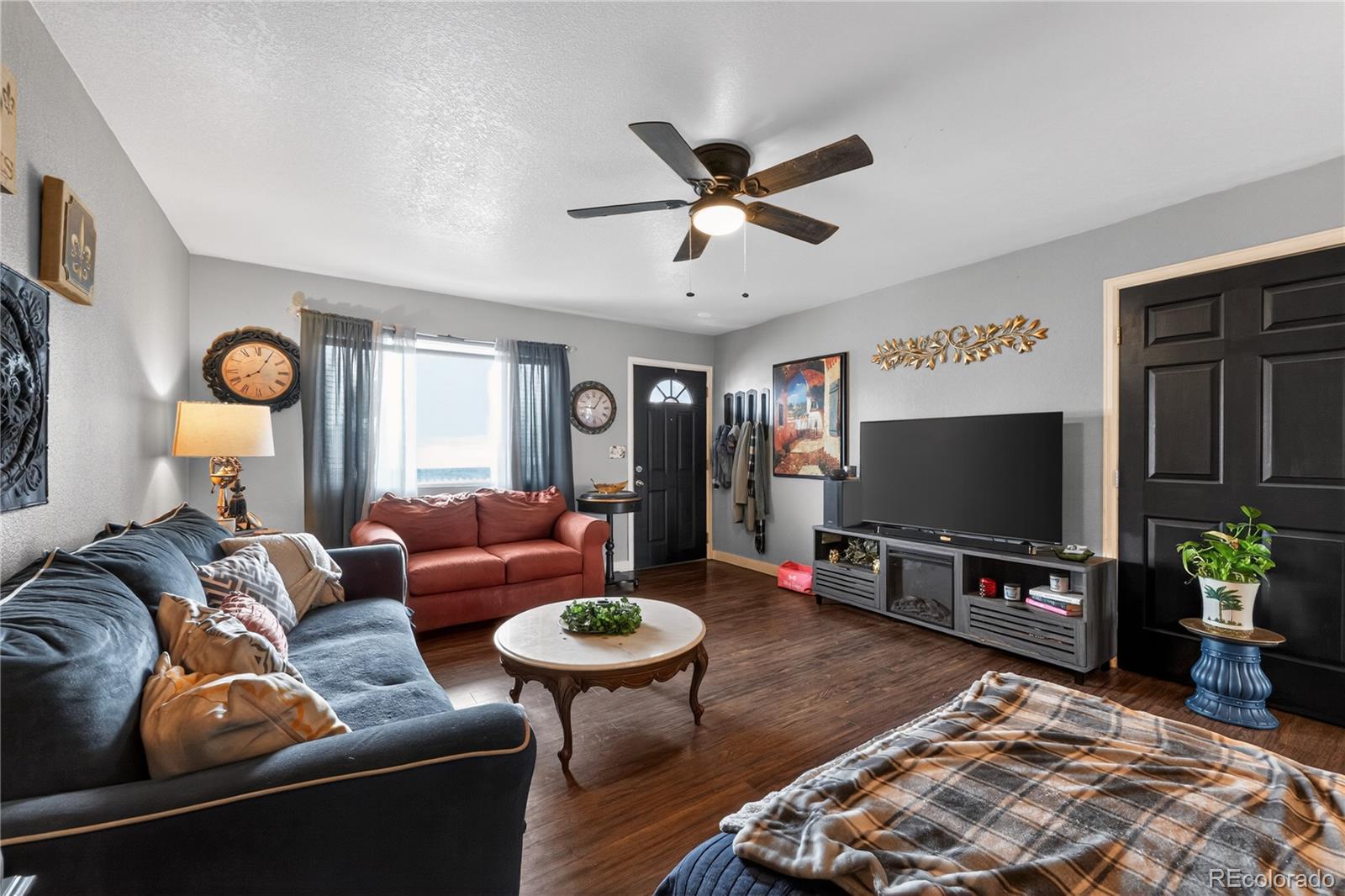 3170 West 3rd Street Road Greeley, CO 80631 - Photo 9 of 29 a living room with furniture and a flat screen tv