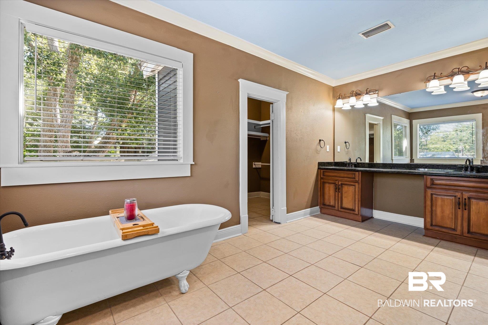 1310 Brown Street Mobile, AL 36604 - Photo 9 of 18 Bathroom featuring vanity, ornamental molding, a bathing tub, and a wealth of natural light