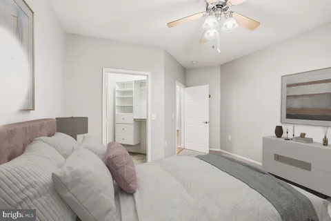 a bedroom with a large bed and a flat screen tv