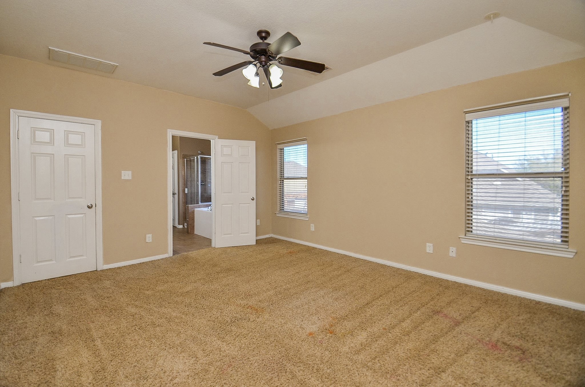5411 Rio Drive Baytown, TX 77521 - Photo 5 of 30 The primary bedroom features two windows for natural light and an en-suite bathroom.